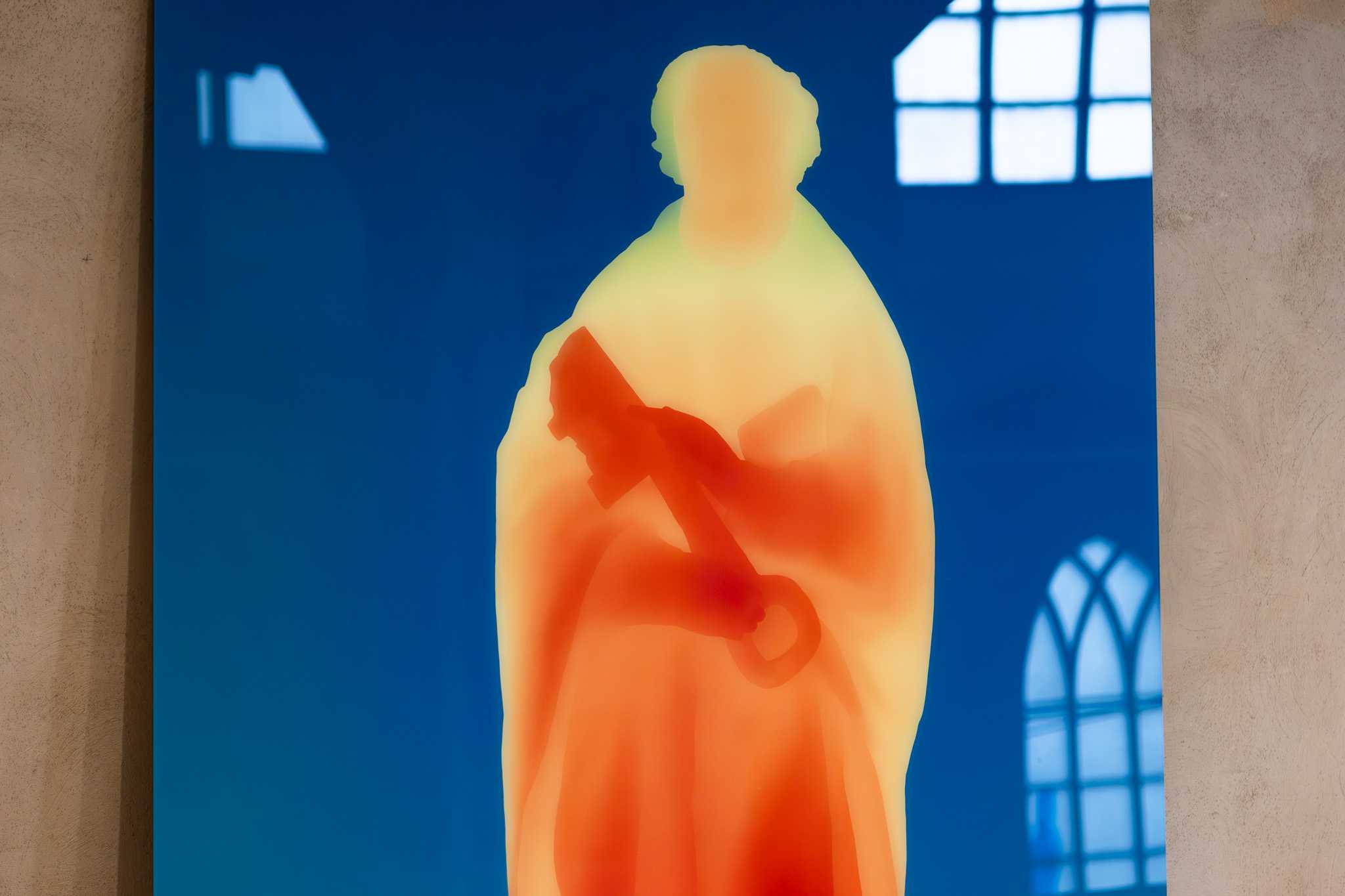 Close view of the same print, the hall's windows reflected across its glossy surface.
