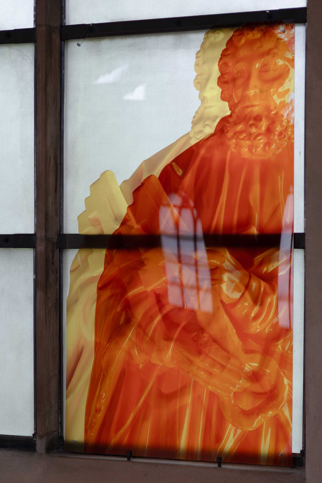 The same print close up: the orange Saint Peter holding his key, his contours doubled where the layers overlap, a dark glazing bar crossing at mid-height.