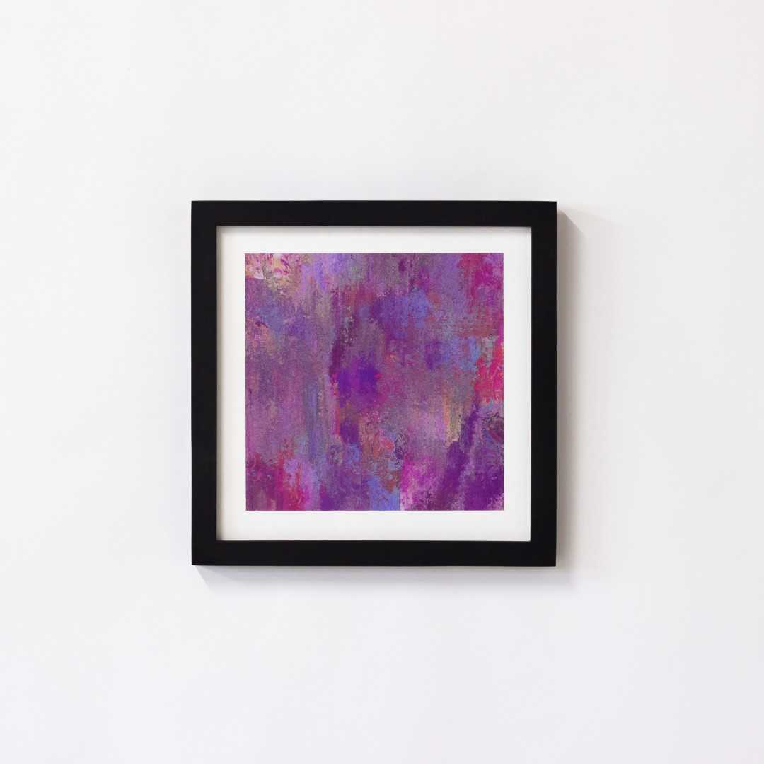 A print of an abstract pink texture in a black frame