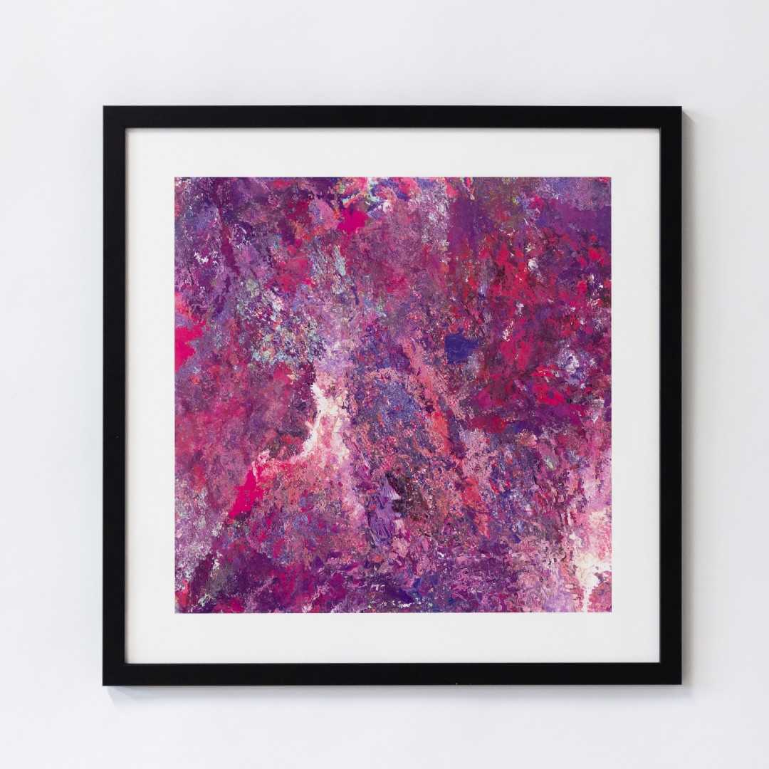 A print of an abstract pink texture in a black frame