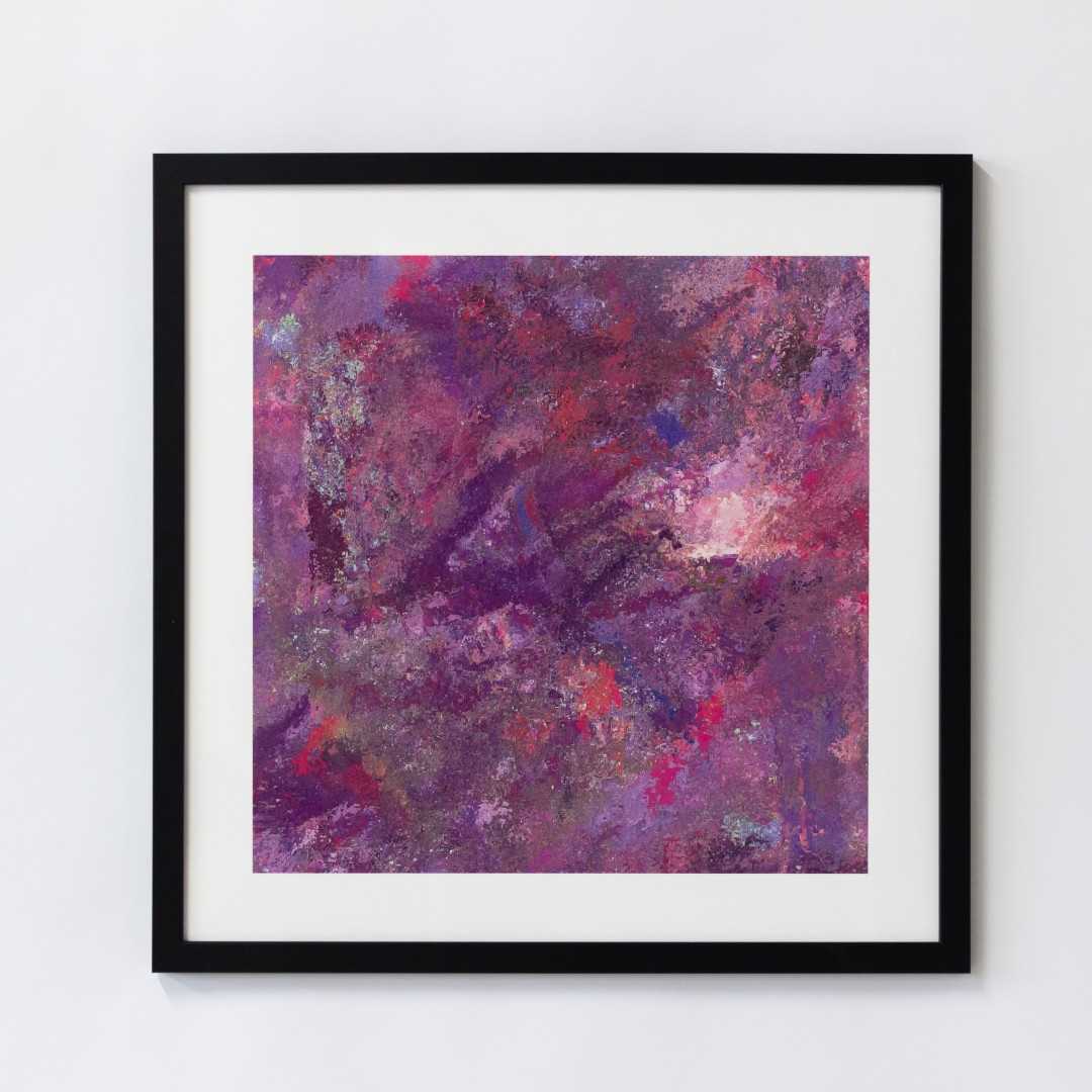 A print of an abstract pink texture in a black frame