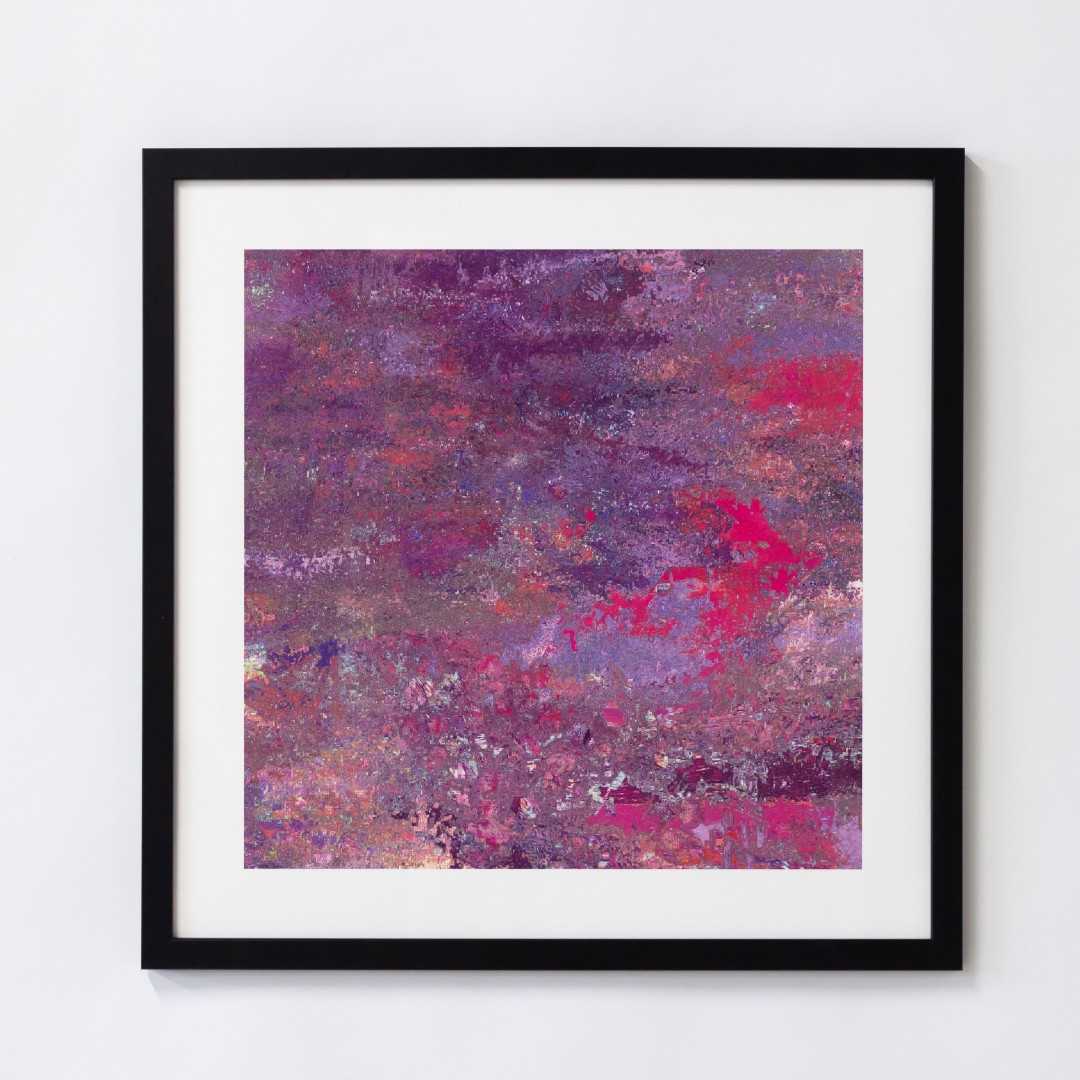 A print of an abstract pink texture in a black frame
