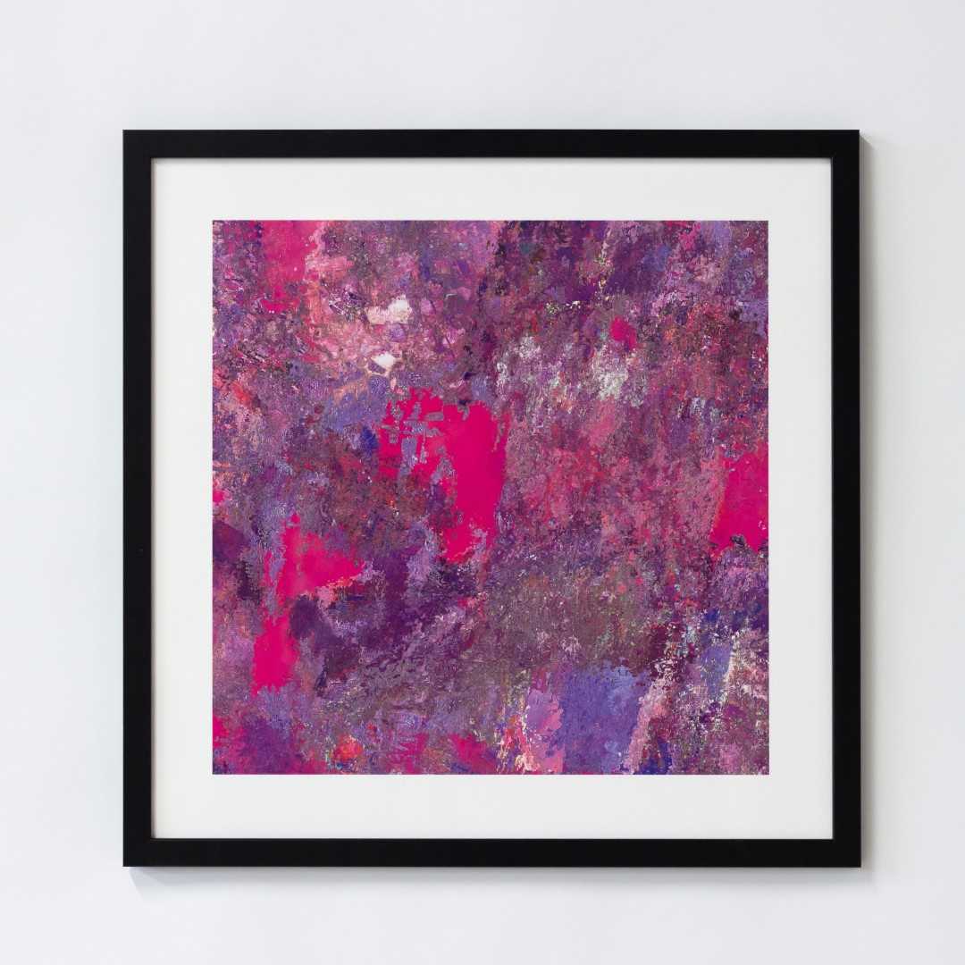 A print of an abstract pink texture in a black frame